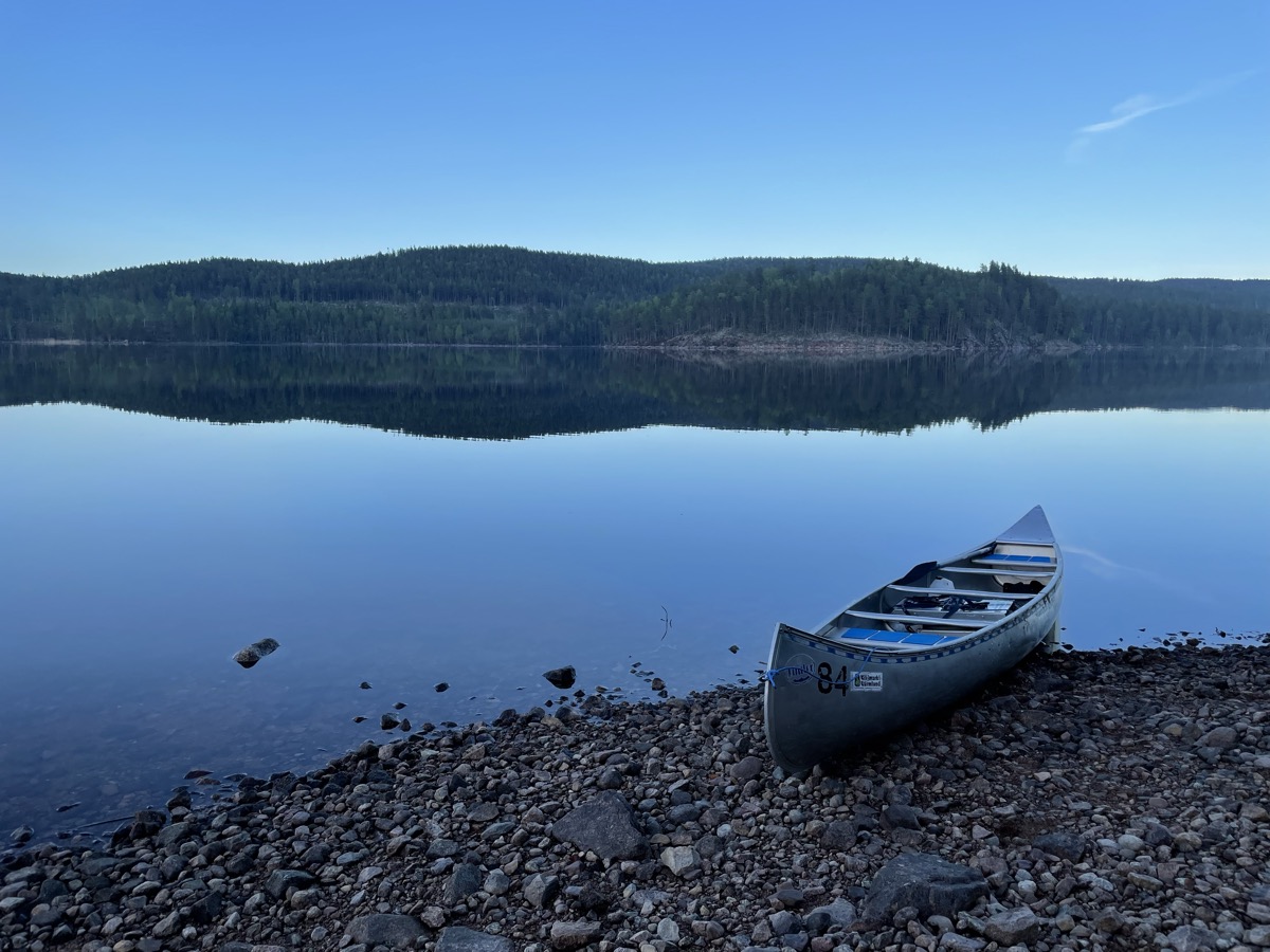 Canoe on a still lake at dusk in Sweden