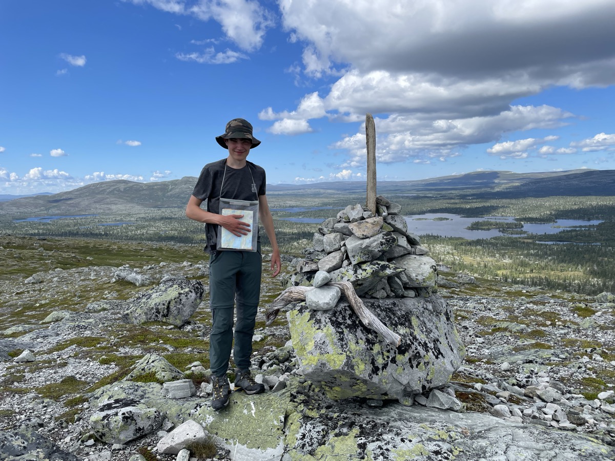 Lewis at a mountain summit cairn in Scandinavia